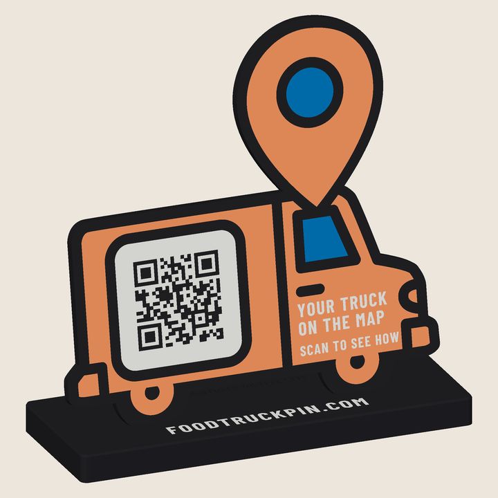 3D-printed orange food truck sign with a location pin on the roof and a QR code as the serving hatch, on a curb reading foodtruckpin.com