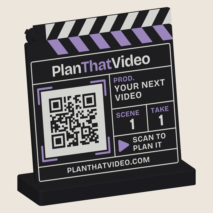 3D-printed PlanThatVideo clapperboard with a striped hinged clapper and a QR code on the slate